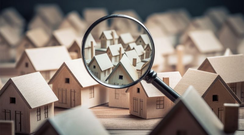 An image of a magnifying glass looking at some models of houses, to support housing supply chain issue article