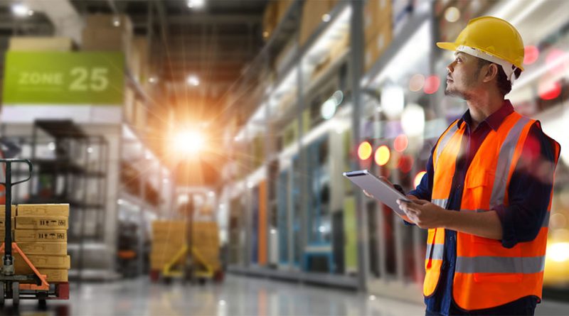 Image of a man in a warehouse surrounded by stock to support supply chain management article
