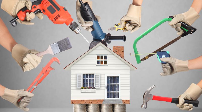 Image of a house model sat on top of a pile of coins with different home improvement tools around it to support Lowes and DoorDash article