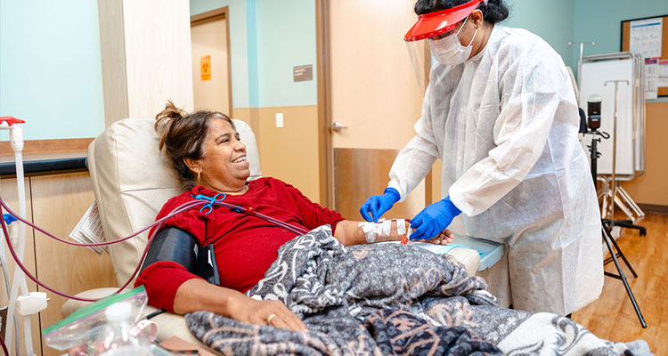 Doctor with patient in a red sweater inside clinic.