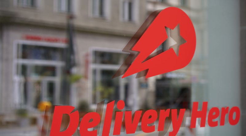 Delivery Hero logo on glass door to support Delivery Hero Glovo fine article