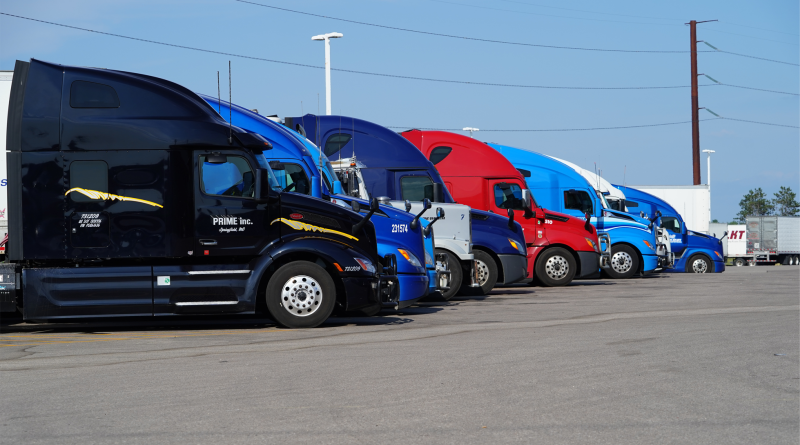 A row of new trucks parked, symbolizing upcoming import tariffs