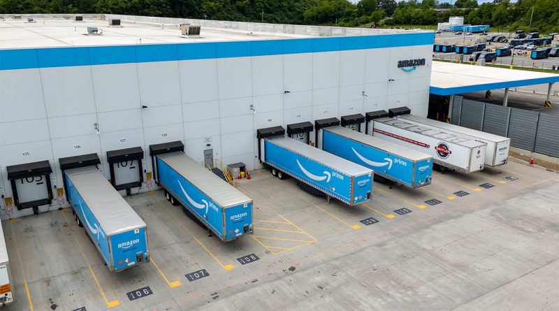 Amazon delivery vans parked at a distribution center as the company evaluates new logistics plans
