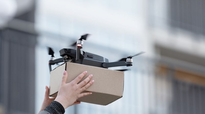 A Wing delivery drone carrying a Walmart package above a suburban neighborhood in Georgia