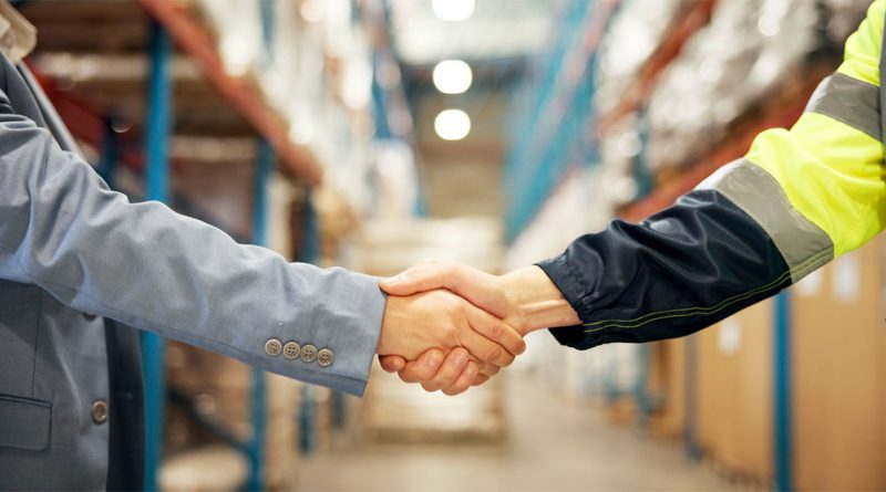 Supply chain executives meeting with suppliers to review performance metrics and collaborative planning data